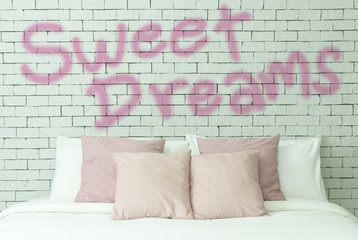 Sweet dreams word on white bricks wall background