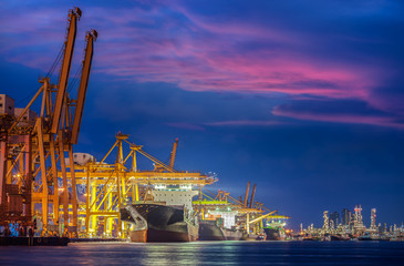 Container Cargo freight ship with working crane bridge in shipya