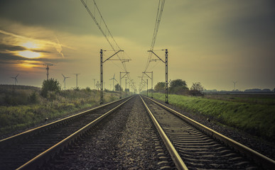 Obraz na płótnie Canvas Train tracks at sunset
