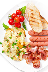 English breakfast - scrambled eggs, bacon, sausage and toast