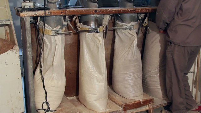 Wheat milling.Worker who control the sacks of wheat flour