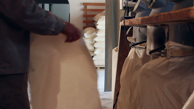 Wheat milling.Worker who control the sacks of wheat flour