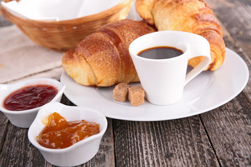 breakfast with coffee cup, croissant and jam