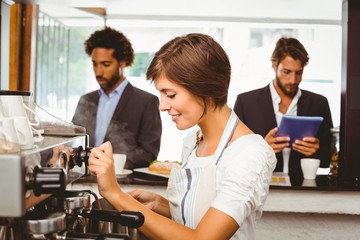 Pretty barista making cup of coffee