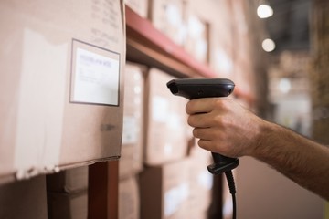Close up of worker holding scanner in warehouse