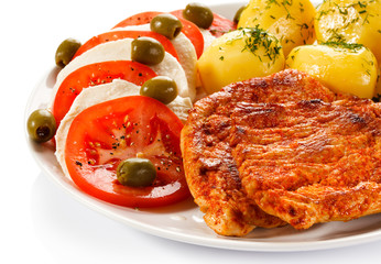 Fried pork chops, boiled potatoes and caprese salad