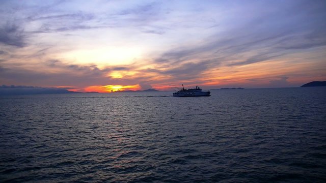 Cruise Ferry Ship Sailing at the Colorful Sunset. Slow Motion.