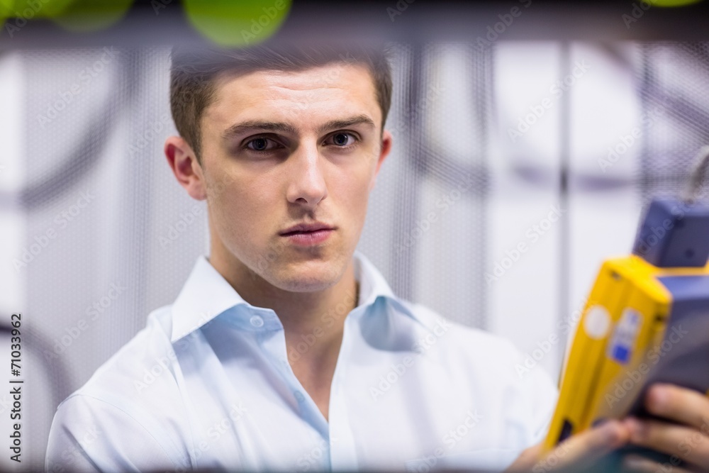 Aufkleber serious technician using digital cable analyzer on server