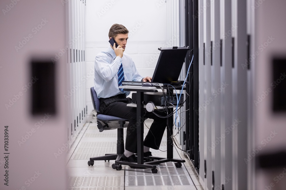 Aufkleber technician talking on phone while diagnosing servers