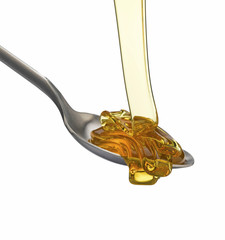 Golden treacle flowing onto spoon