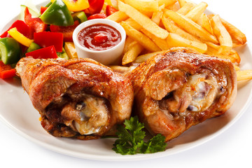 Grilled turkey legs with French fries and vegetables