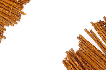 salted pretzel sticks diagonal, white background,copy space