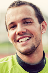 Obraz premium Portrait of a young active man smiling during sport training