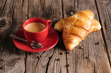 Croissants and coffee on wooden table