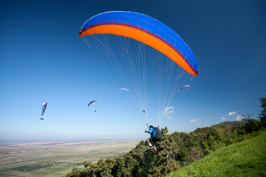 Group of paragliders in flight
