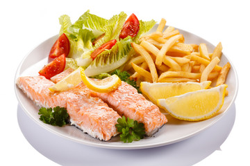 Grilled salmon and vegetables on white background