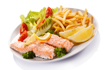 Grilled salmon and vegetables on white background