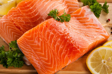 Fresh raw salmon fillet on cutting board