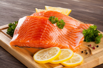 Fresh raw salmon fillet on cutting board