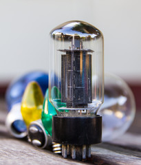 Still life of the tube amplifier set to tungsten on old wood.
