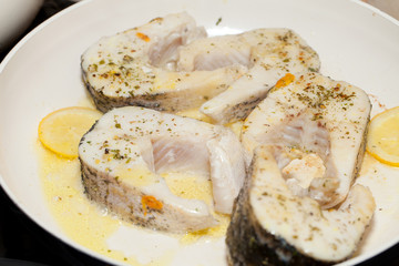 The fried fish on the frying pan