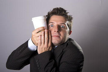 maniac caffeine addict businessman holding take away coffee