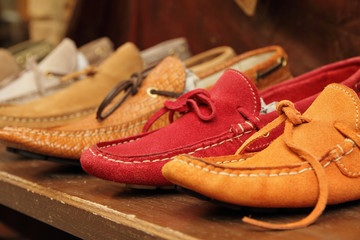 colorful moccasins style shoes on shelf by italian shoe maker