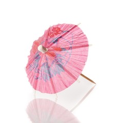 pink cocktail umbrella isolated against white background