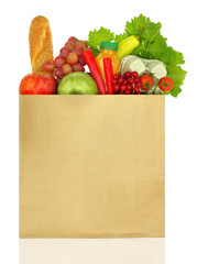 Paper bag full of groceries isolated on white