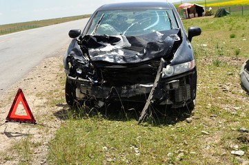 accident car and warning triangle on roadside