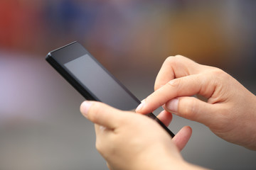 young woman hands use cellphone in city 