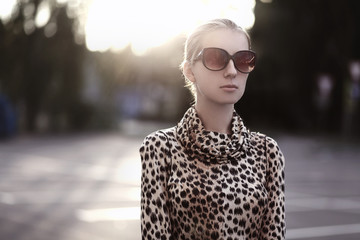 Fashion lifestyle portrait woman in sunglasses, leopard dress