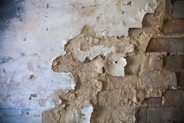 Damaged whitewashed plaster on the brick wall © rootstocks