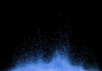 BLue dust explosion isolated on black background