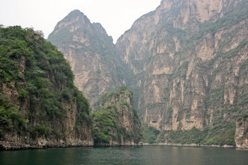 Steep high cliffs and the river at the bottom of the gorge.