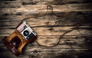 Old photo camera on wood