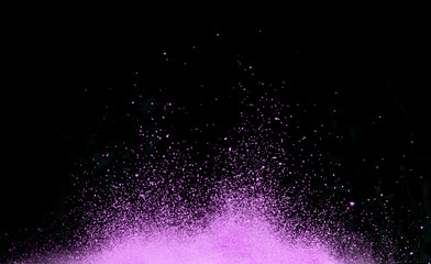 Purple dust explosion isolated on black background