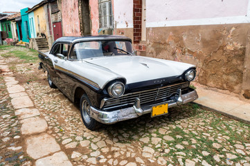 Street scene with vintage car in HTrinidad, Cuba.