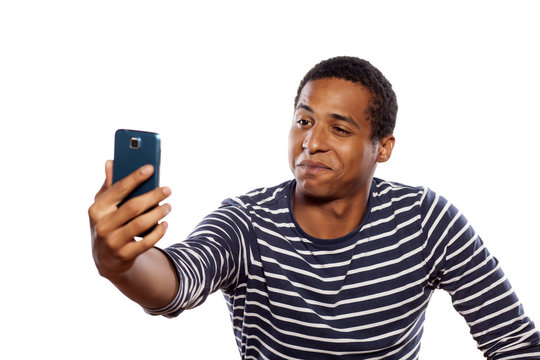 Smiling Dark-skinned Young Man Making Selfie On White Background