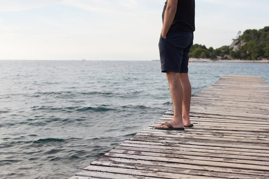 Lonely Man Standing On Pier