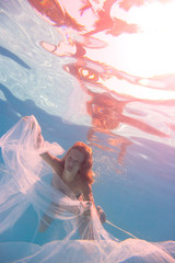 Young woman swimming undewater