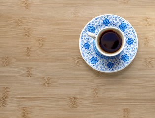 A cup of Turkish coffee on a wooden background