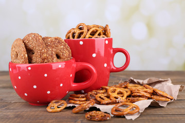 Dry breakfast, sticks and biscuits in red polka dot cup and