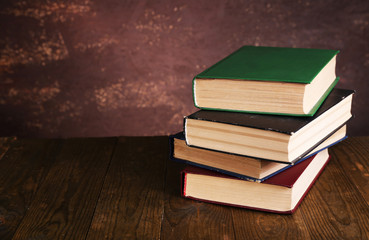 Books on wooden table on dark background