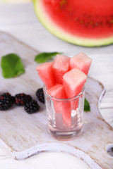 Pieces watermelon in glass on wooden table