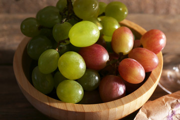 sweet grape in wooden bowl, close up
