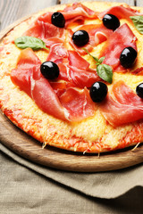 Delicious pizza served on wooden table