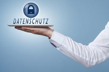 Hand hält Tablet darüber das Wort Datenschutz und Symbol Schloss
