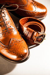 Classic polished men's brogues and brown belt
