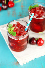 Closeup of cherry granita in glasses, on color wooden